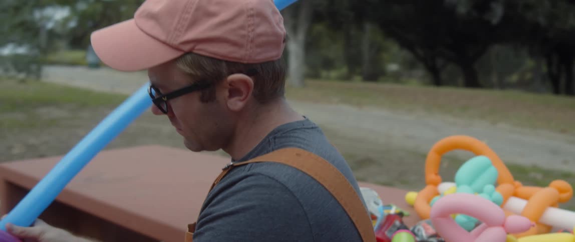 A man is making balloon animals