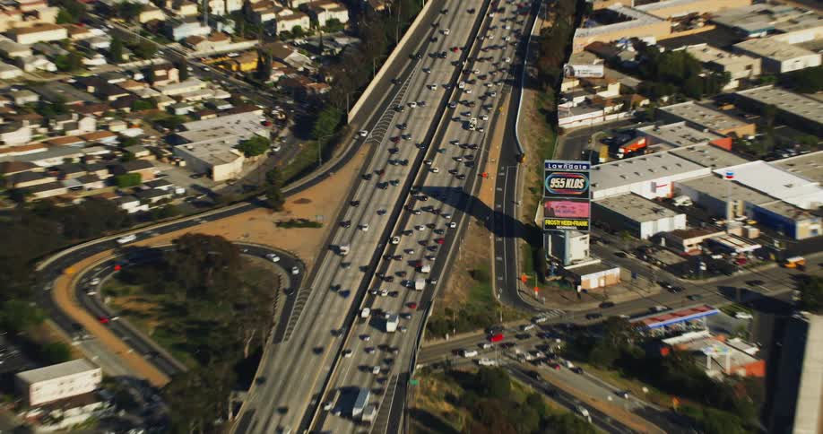 Aerial view of cars driving on a highway in a city