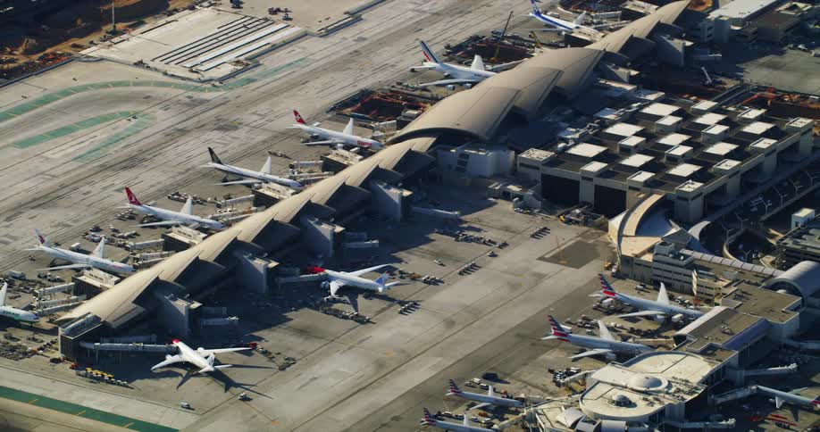 Airplanes and jets parked at a hangar