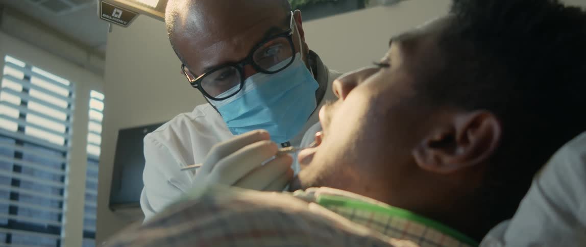 A dentist examines a patients teeth