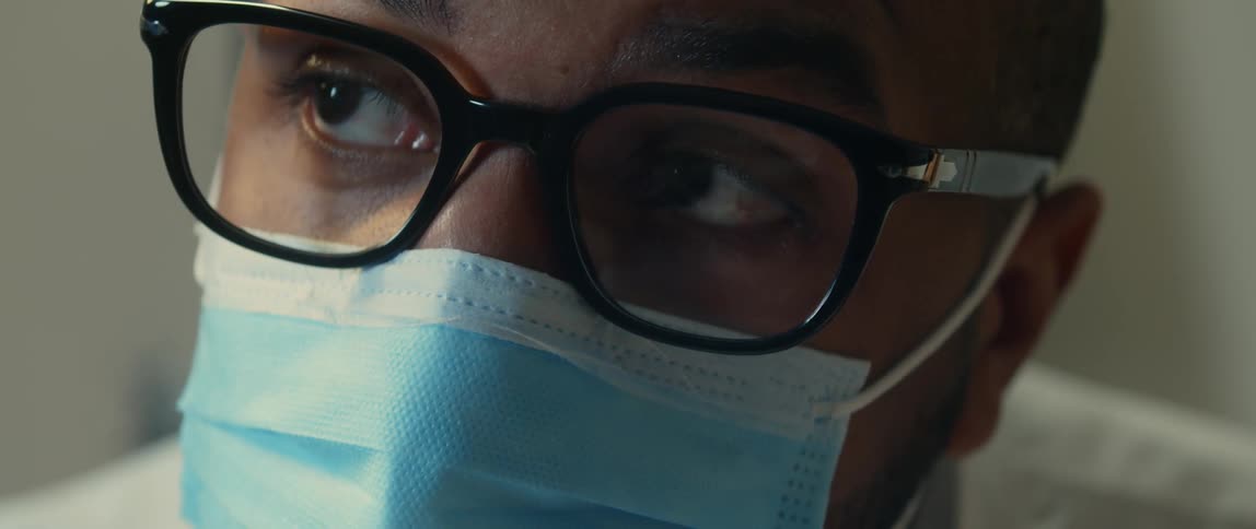 A male dentist examining a patients teeth