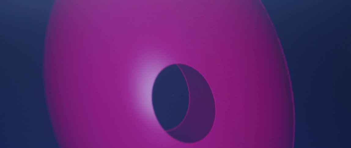 Close up of an spherical purple 3d object being rotated on a screen