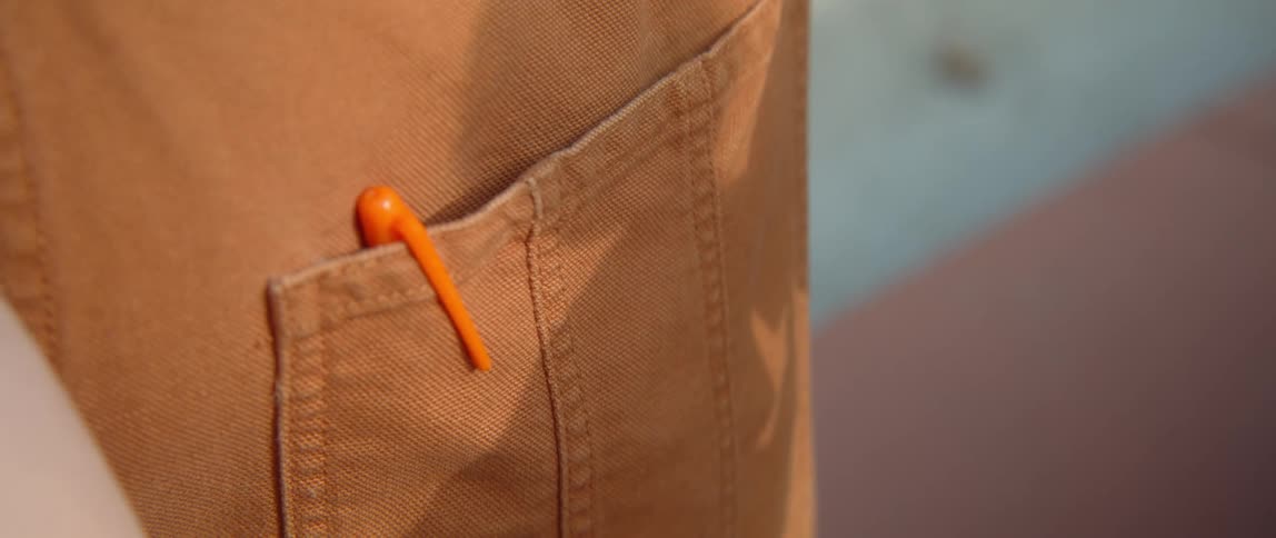 A person with a pen in their pocket