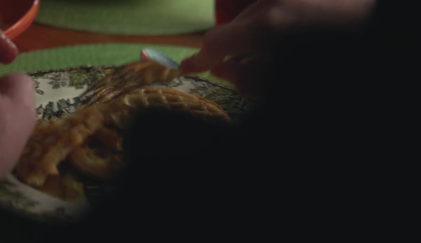 Close up of a young man eating waffles at breakfast in the morning