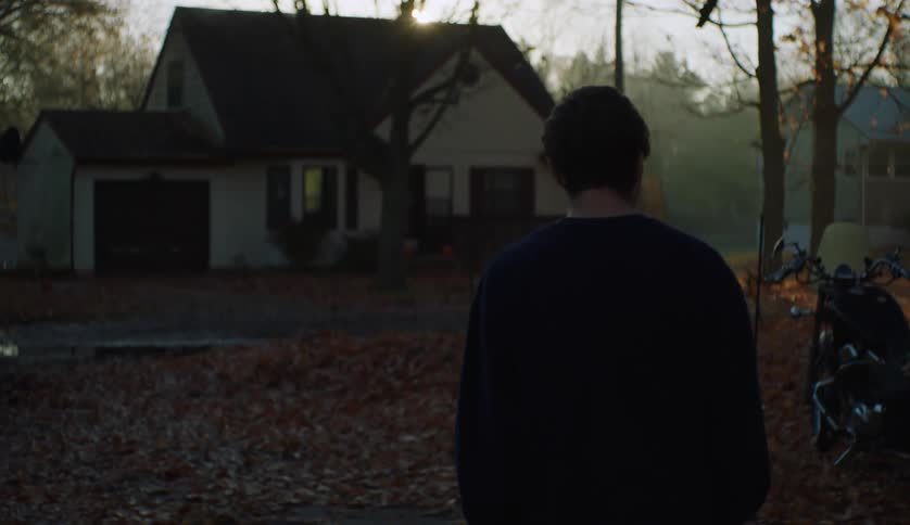 A man walks towards the house