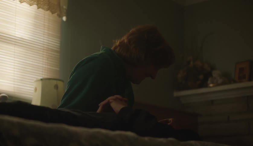 Two adults are hanging out inside of there room in the day time