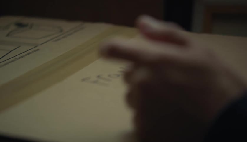A person is writing on a piece of paper