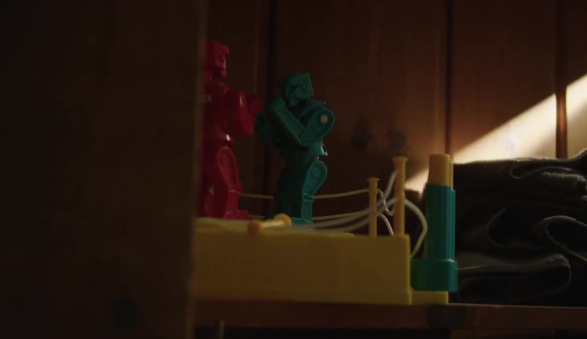 Vintage toy rockem sockem robots sitting on a shelf