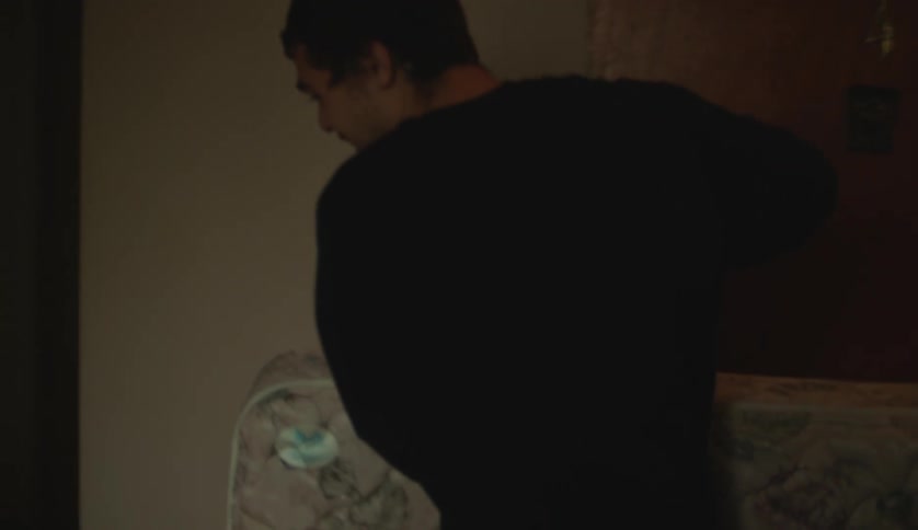 Two people are carrying a bed into the house
