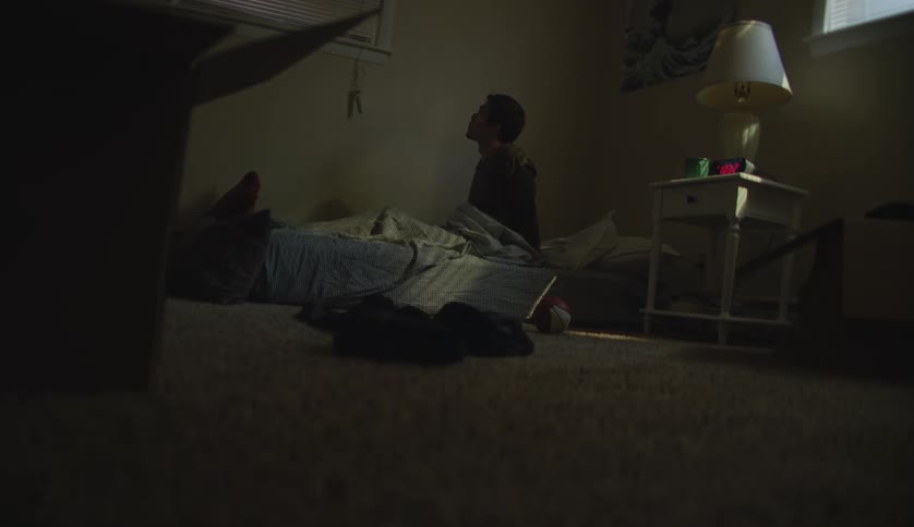 A boy wakes up from bed