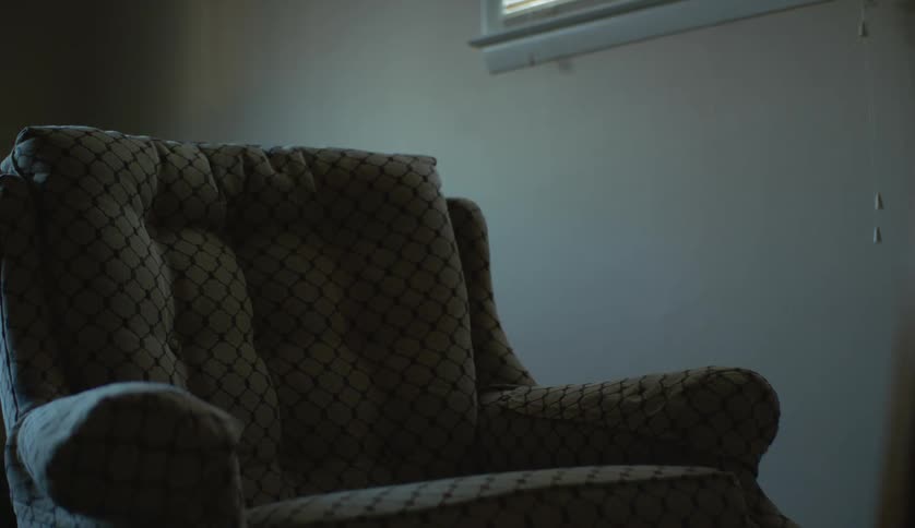 The view is of inside of the living room and you can see a chair