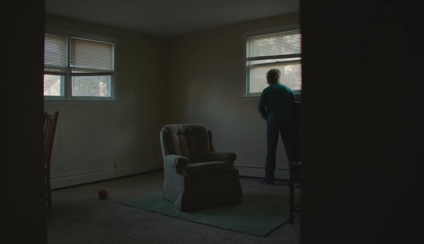 A man walking around in an empty house