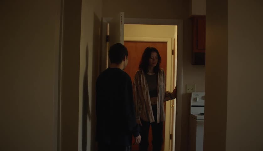 Two people are walking around their home