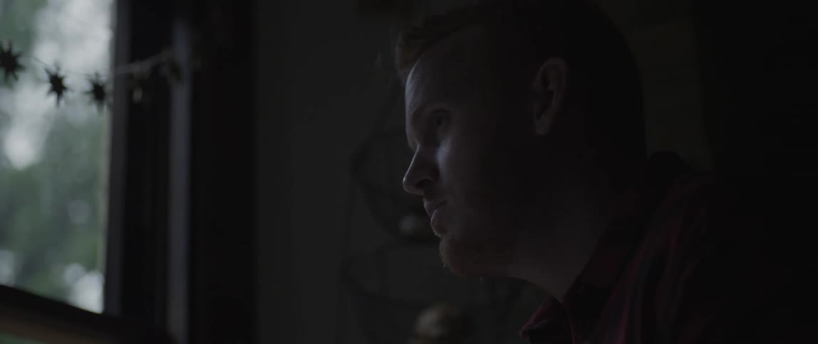 A man stares through a window