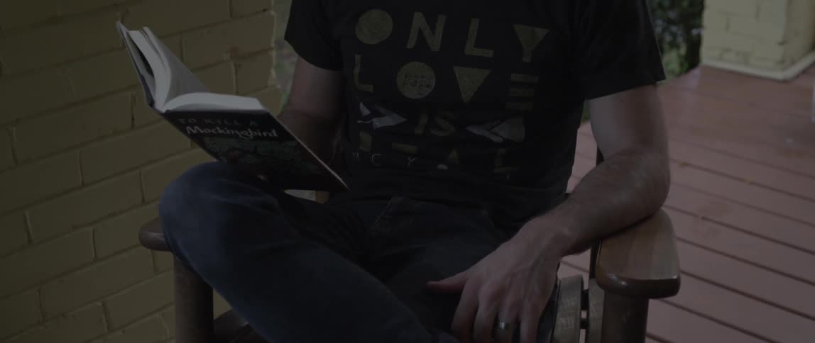 A man is sitting down reading