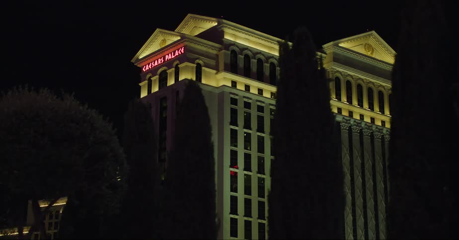 The view is of the city area at night time and you can see buildings