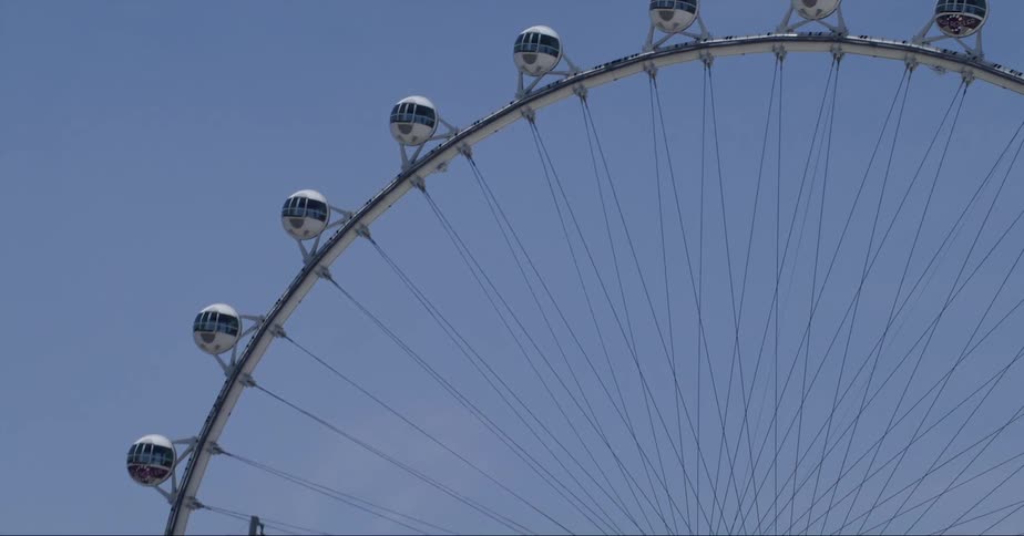 The view is of a ferris wheel in the middle of the day time