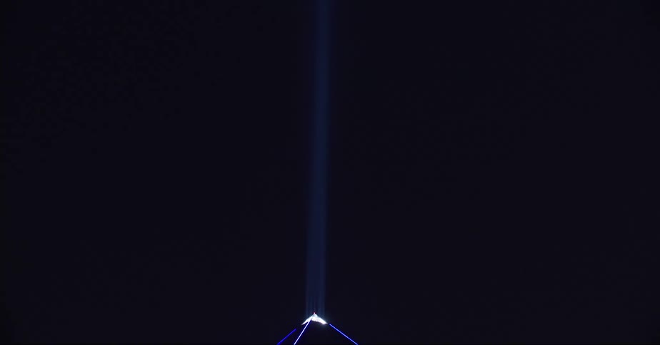 Light shines into the sky from the pyramid