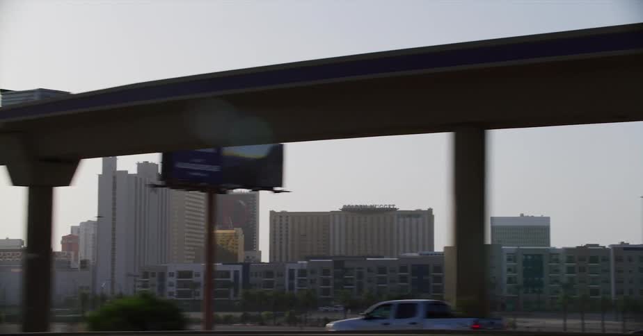Overpasses and apartment buildings seen from vehicle driving on highway