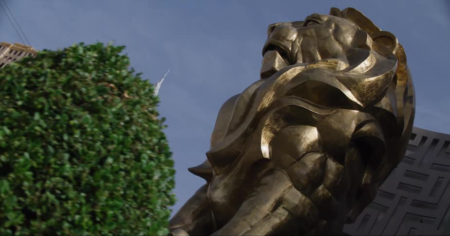 Lion sculpture sits in plaza near downtown buildings