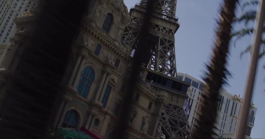 The eiffel tower surrounded by buildings and hotels