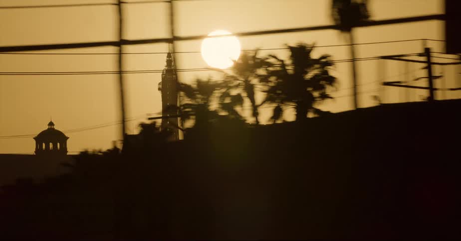 The sun shining down on towers in a city