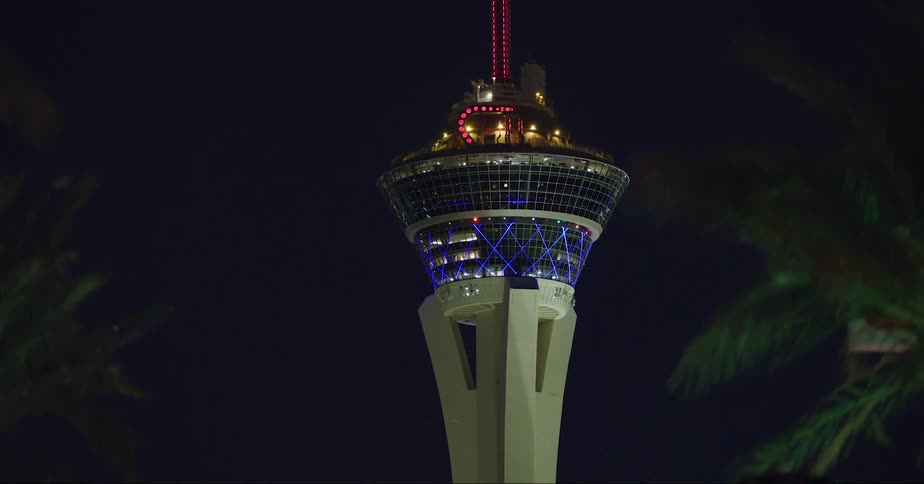 The stratosphere tower in las vegas seen from a moving vehicle at night