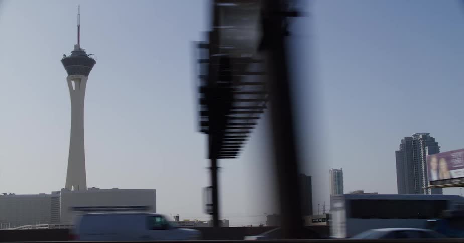 Heavy traffic on an urban street with skyscrapers in the distance