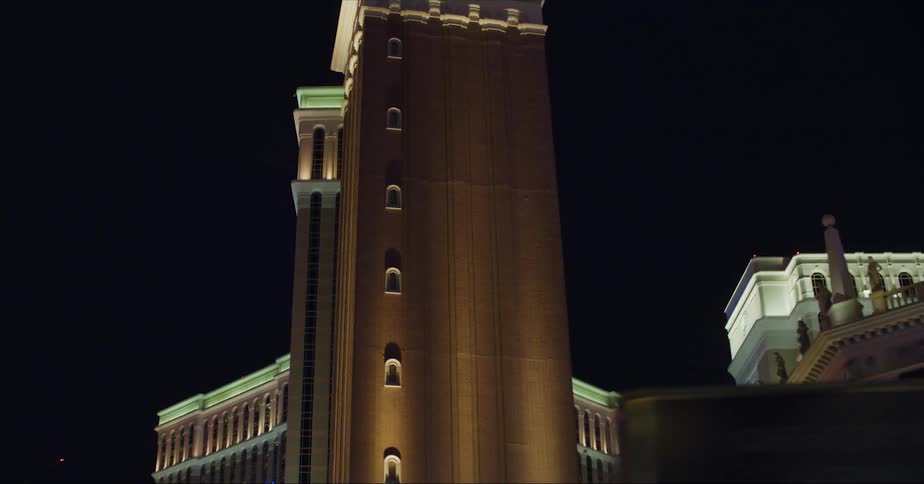 Bell tower stands near casinos and other businesses on las vegas strip at night