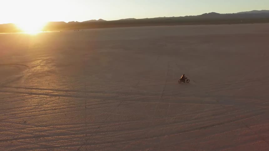 A person drives across the desert