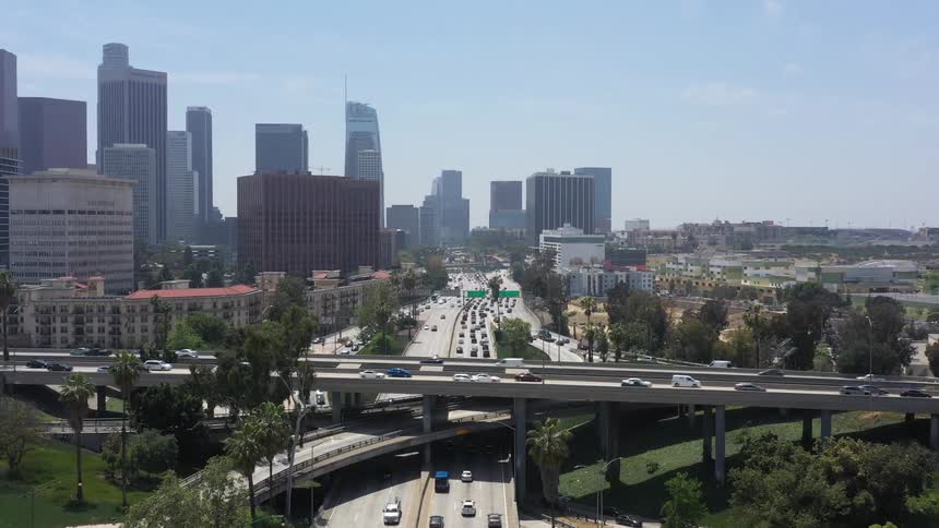 Busy Freeway interchange with DTLA behind