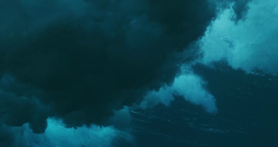 Underwater footage of waves rolling overhead on the blue ocean waters