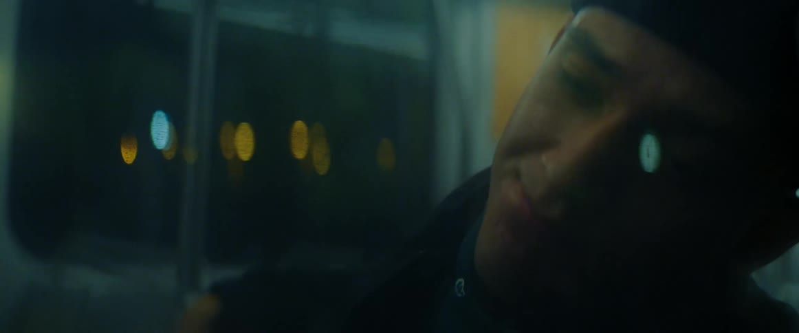 A man is on a public bus during the night time