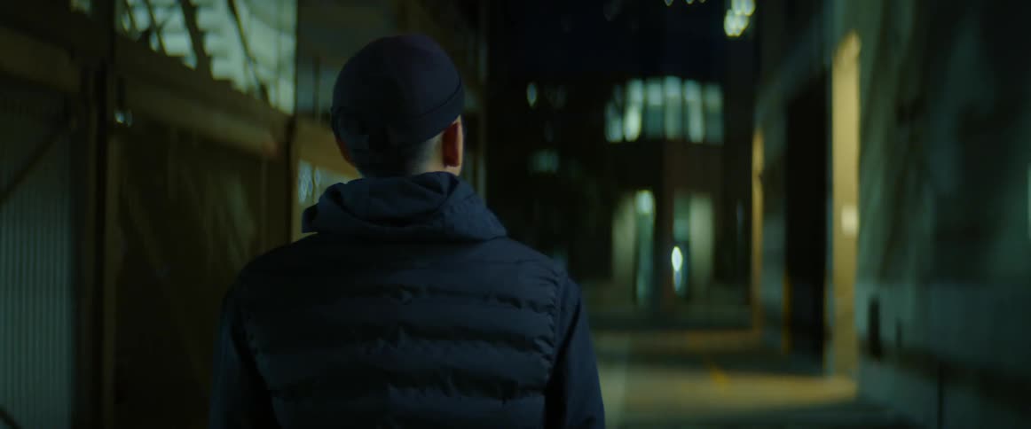 Man walks through large building looking around