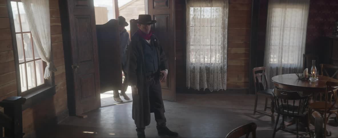 A gun man walks into a saloonconfronting people before leaving