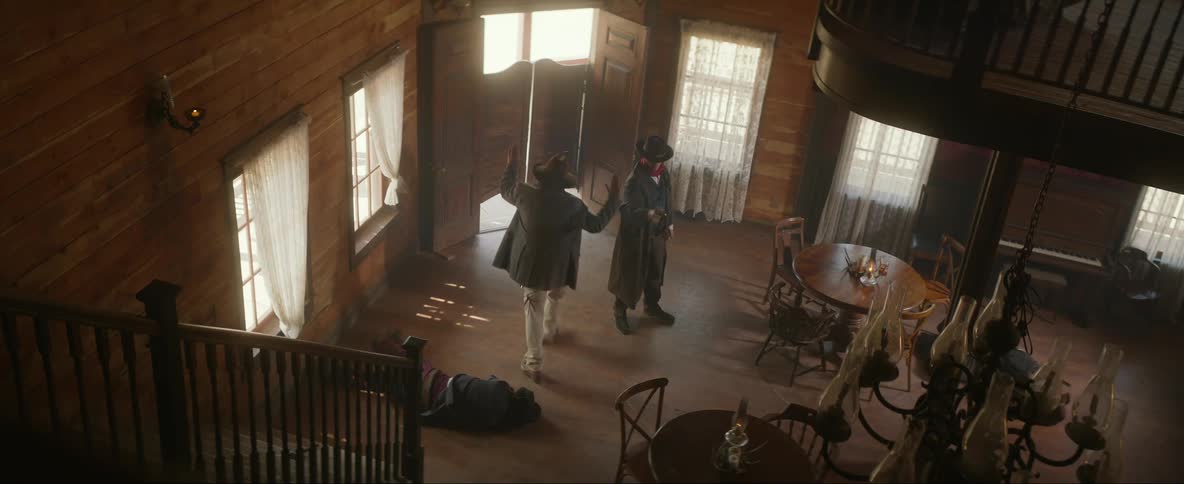 Male gunfighter walks into old west saloon and engages in gunfight