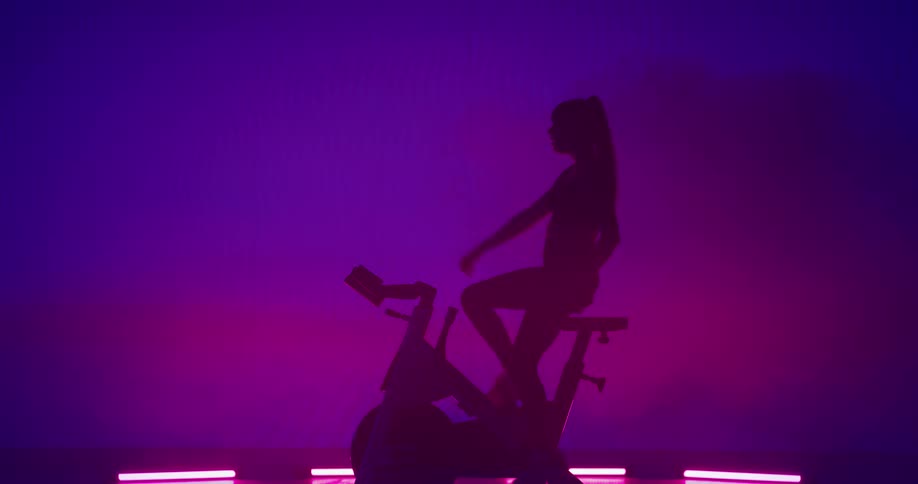 A woman is exercising in a room by herself