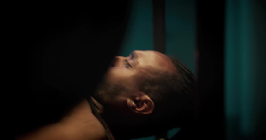 A man is lying on a bench press lifing weights