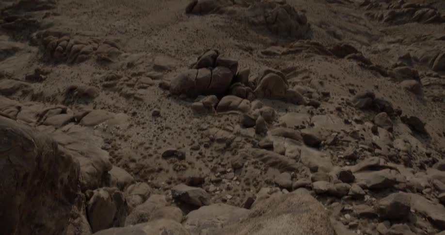 Landscape of rocky hills seen from a high area of rock with a very steep side