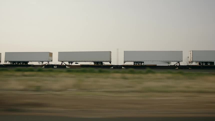 A train driving through rural Texas at sunset