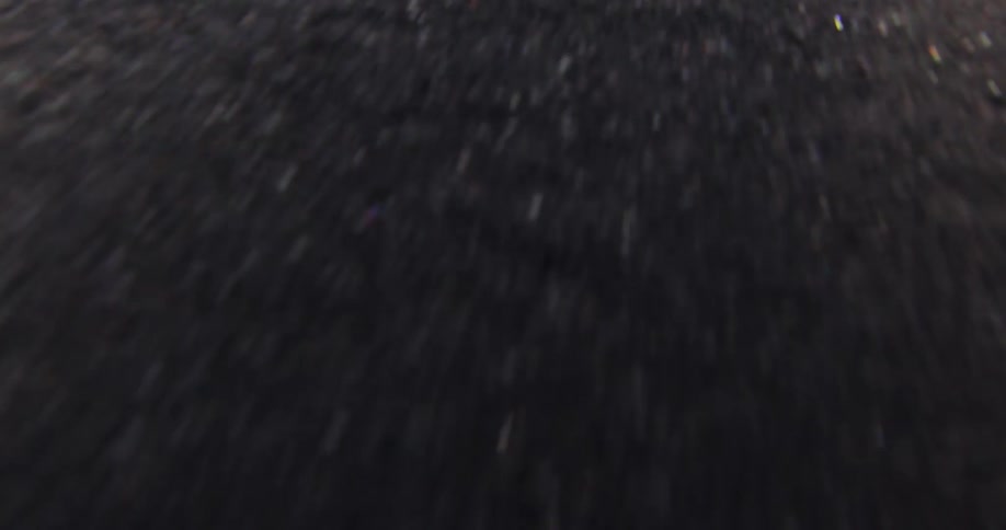 Close up of the pavement on the surface of a road moving underneath
