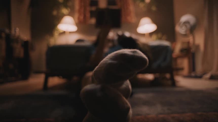 Close up of wiggling feet wearing socks on the floor of a bedroom