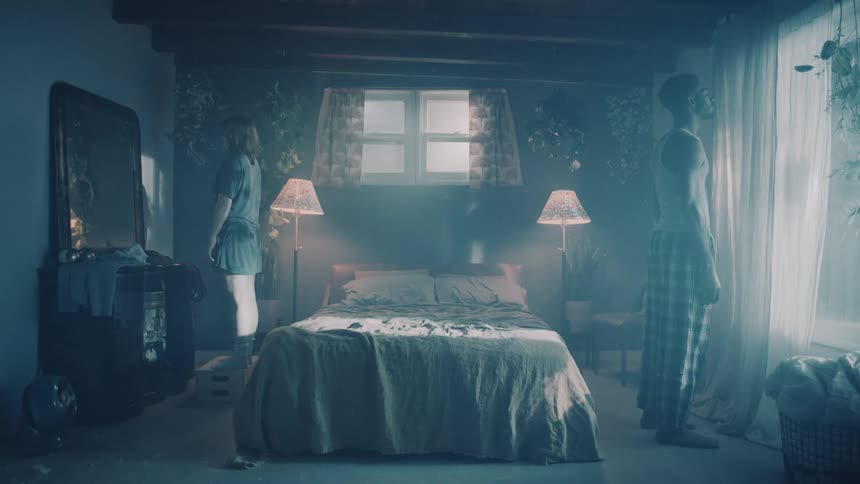 Young couple standing opposite to each other on a room with surreal atmosphere