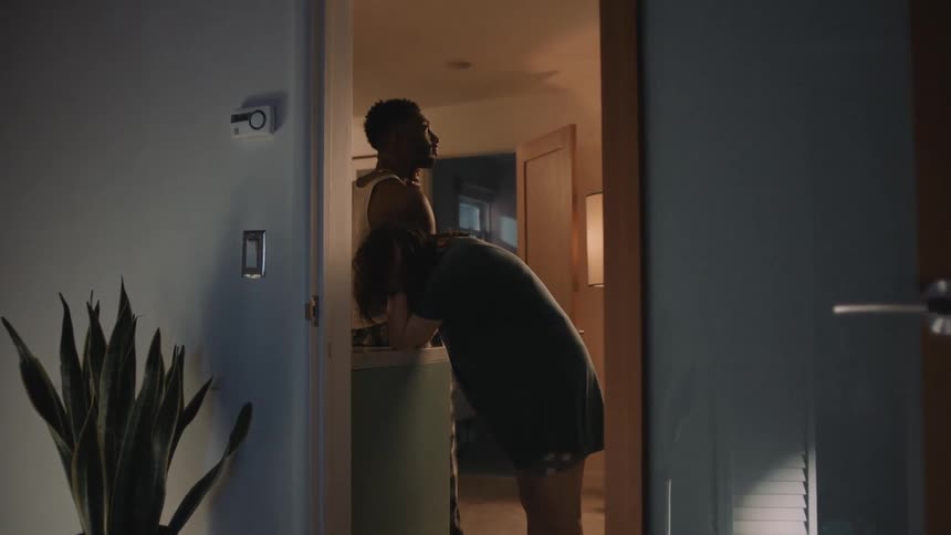 Young tired couple stand next to each other inside a room at home