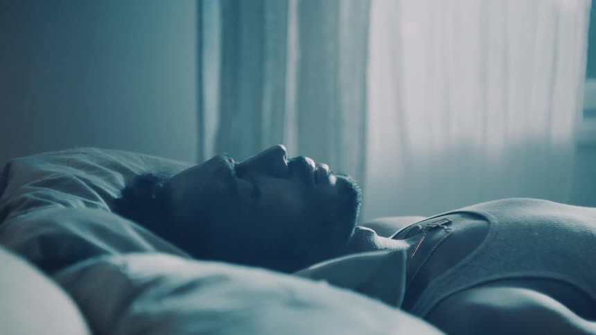 A man falls into bed sleeping