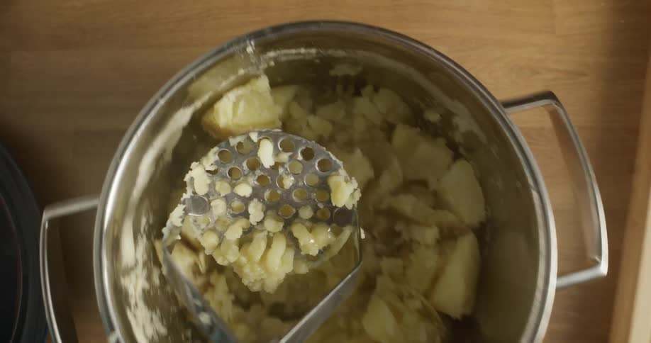 A person is preparing a meal with potatoes
