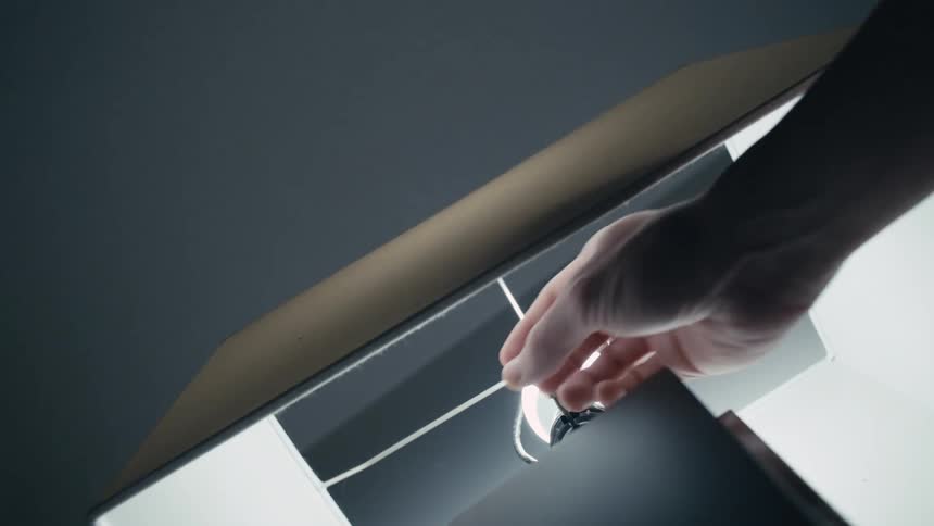 A person turning off a lamp