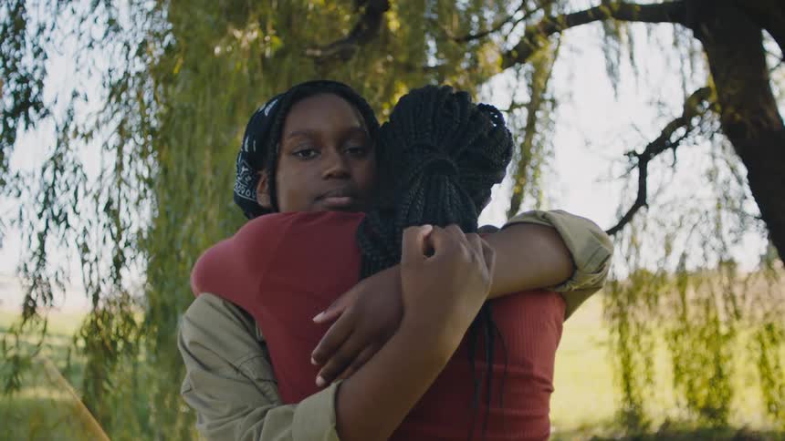 Two women hug outside