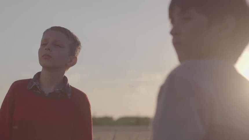 Two kids standing outdoors