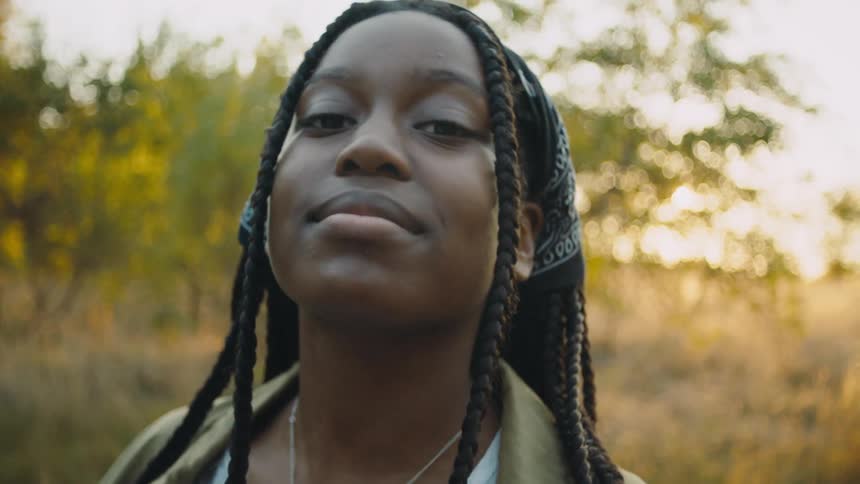 A black girl smiles into the camera